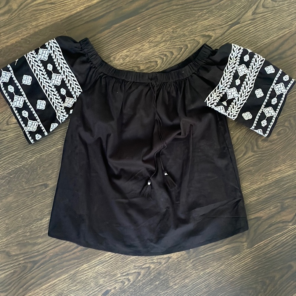 Women’s off-shoulder blouse with embroidered detail. New. Never worn